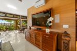 The living room features a large flat screen TV
